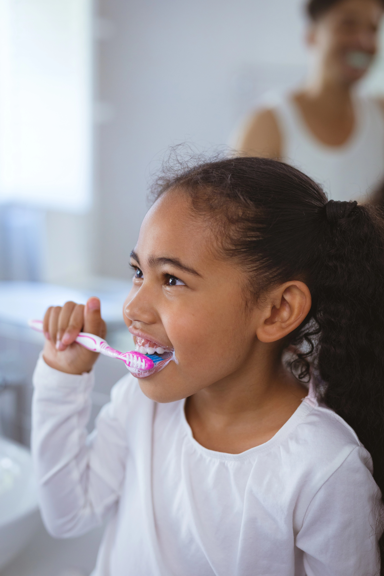 Young girl brushing teeth