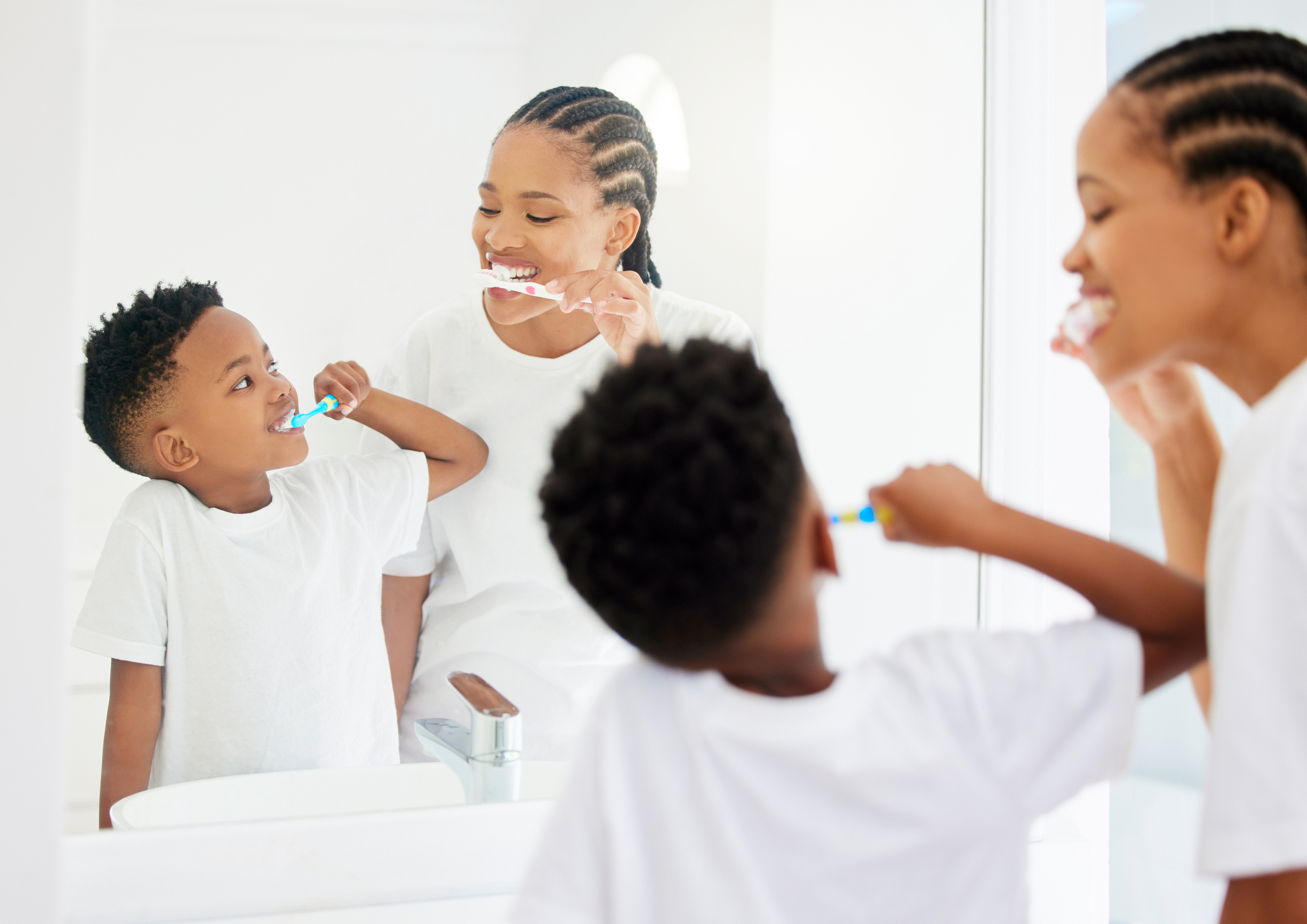 Happy, mother and boy with toothbrush for brushing teeth for dental health, daily routine and gum wellness. Black family, back and mirror in bathroom or home for oral hygiene, cavity and fresh breath.